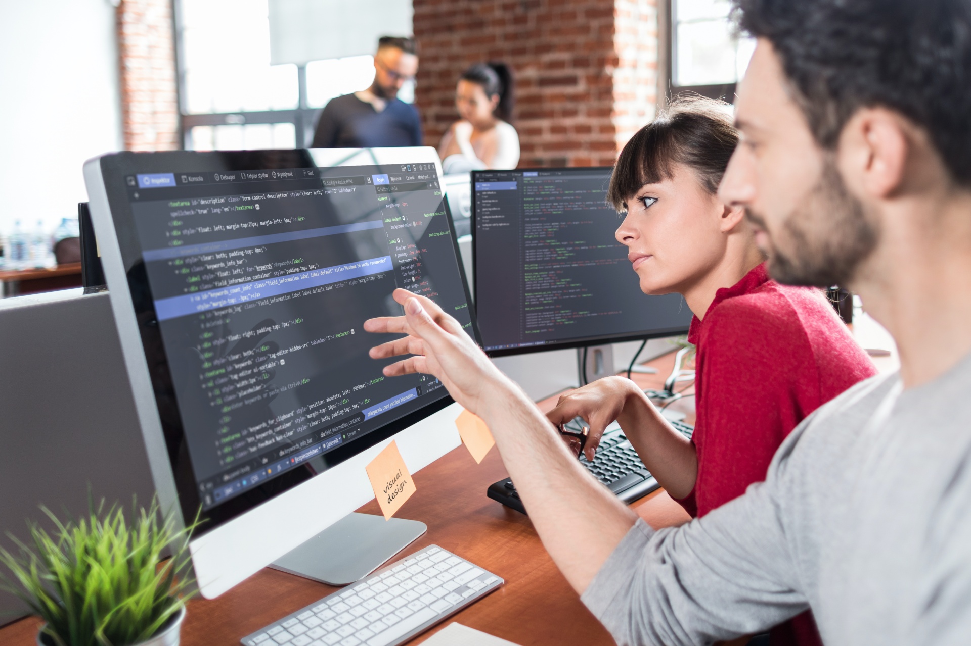 Man pointing at website code on a computer